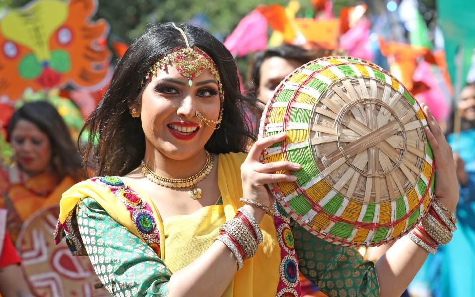 Smiling woman dancing at a street celebration